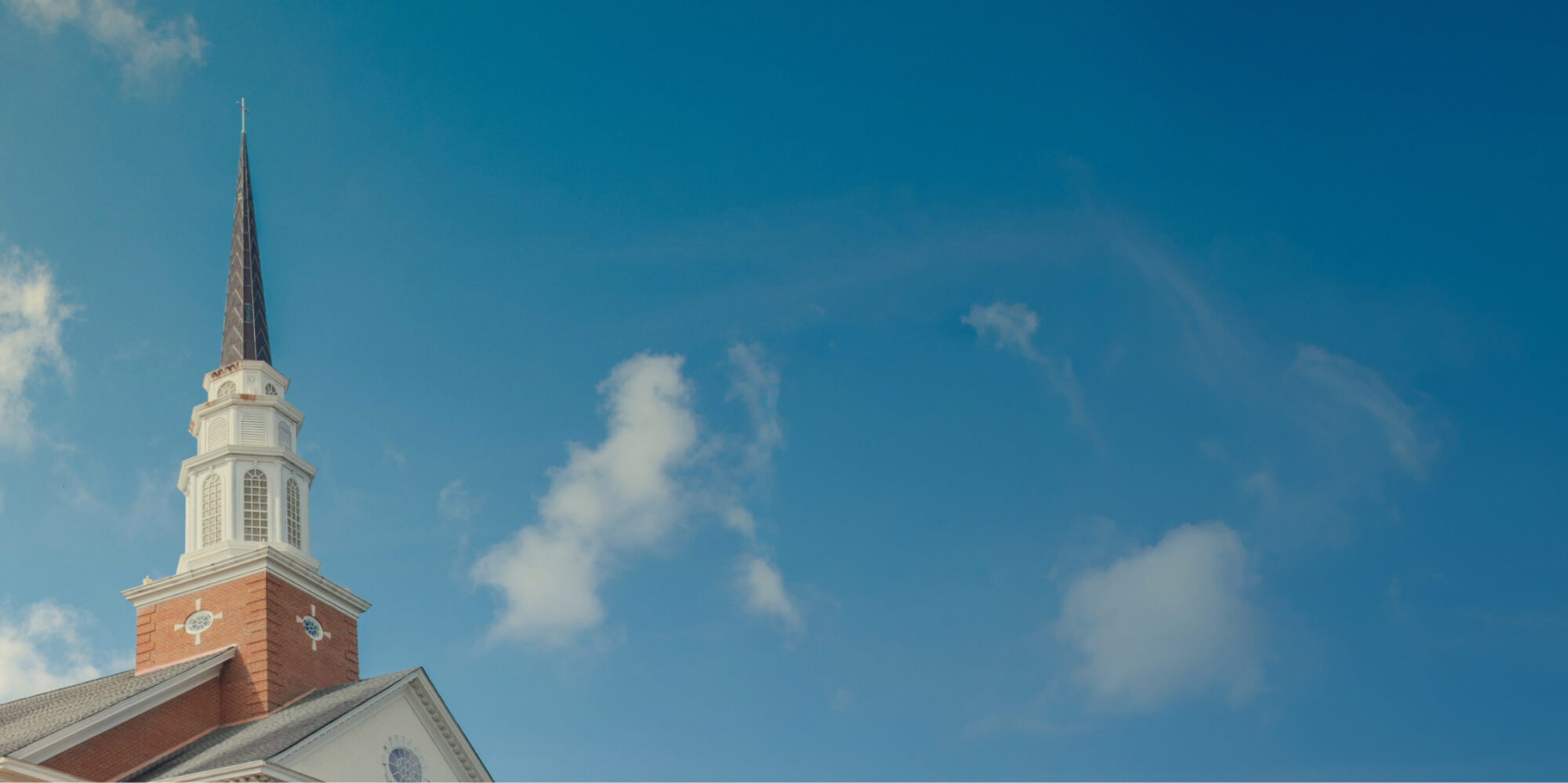 Mount Vernon Baptist Church steeple against a blue sky.
